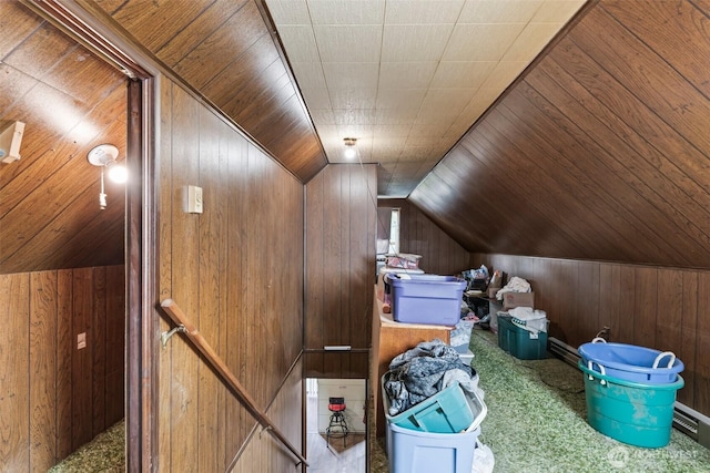 bonus room featuring carpet, wood walls, and vaulted ceiling