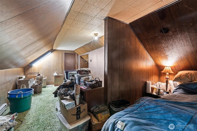 bedroom featuring wooden walls, carpet floors, and vaulted ceiling