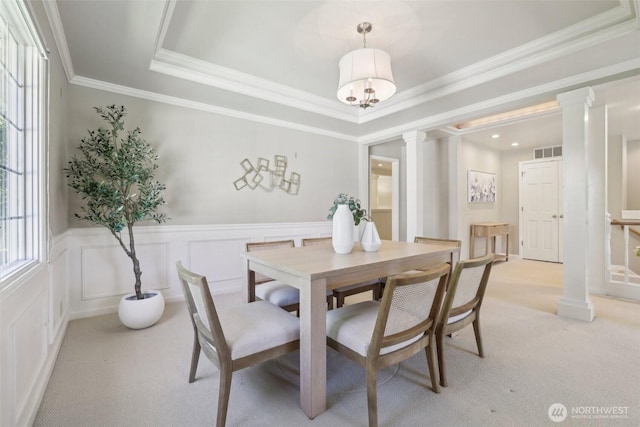 6222 139th Pl SE, Bellevue, WA 98006 - dining space with ornate columns, light carpet, a wainscoted wall, a raised ceiling, and crown molding