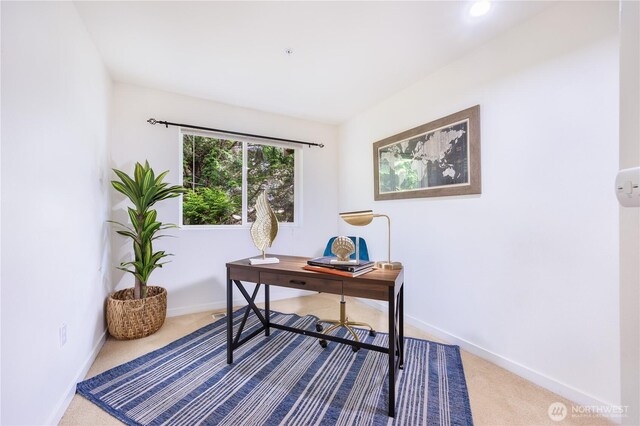 carpeted office space featuring baseboards