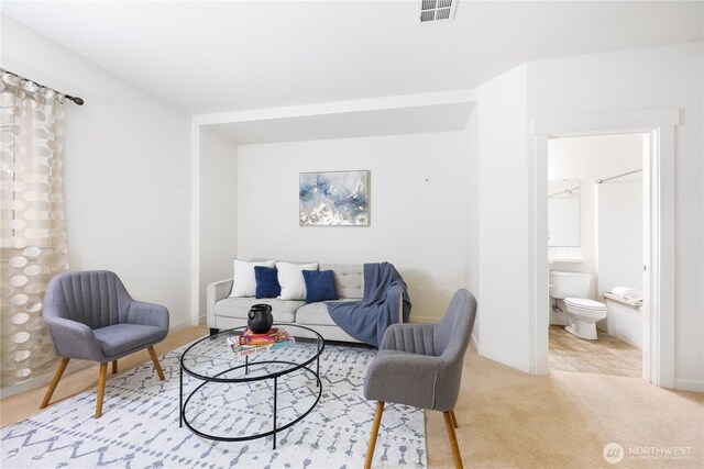 carpeted living room featuring baseboards