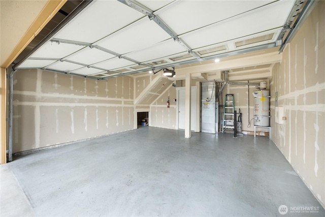 garage featuring strapped water heater and a garage door opener