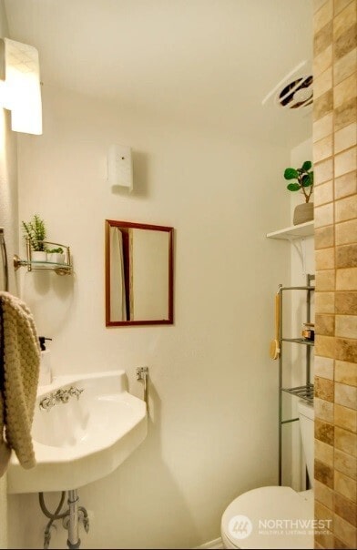 bathroom with toilet and a sink