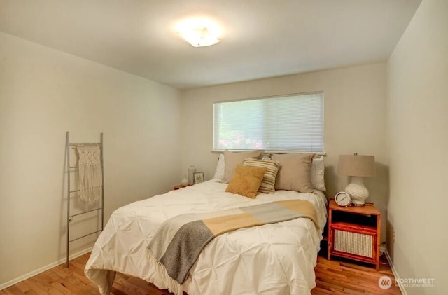 bedroom featuring wood finished floors and baseboards