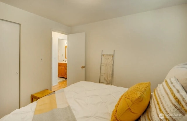 bedroom featuring light wood finished floors and a closet
