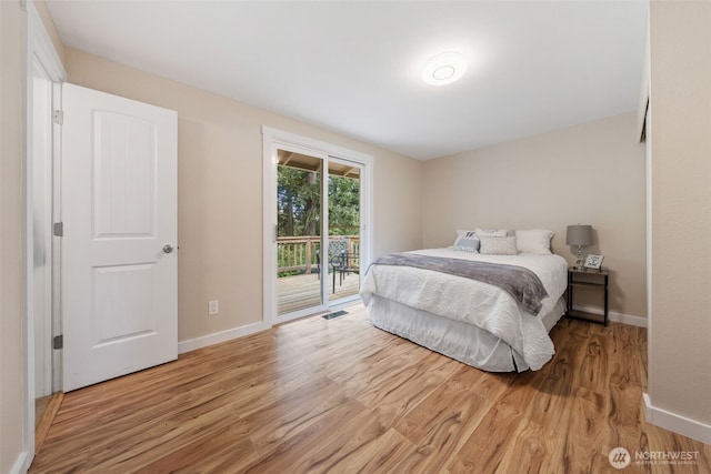 bedroom featuring access to outside, light wood-style flooring, and baseboards