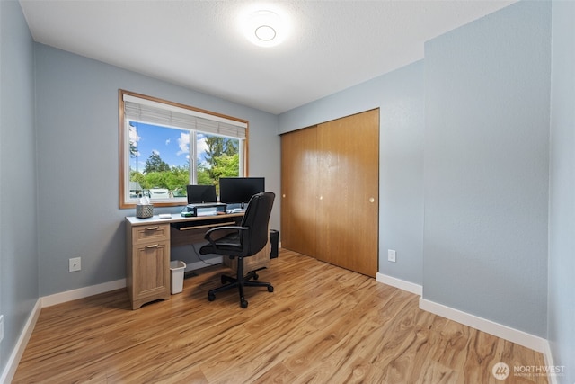 office with light wood-style floors and baseboards