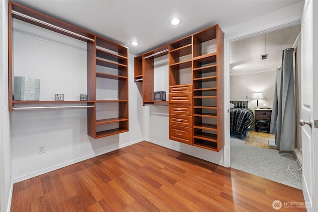 spacious closet with wood finished floors