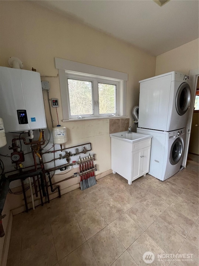 1133 Parkridge Dr, Port Townsend, WA 98368 - laundry room featuring stacked washer / dryer, water heater, and light tile patterned flooring