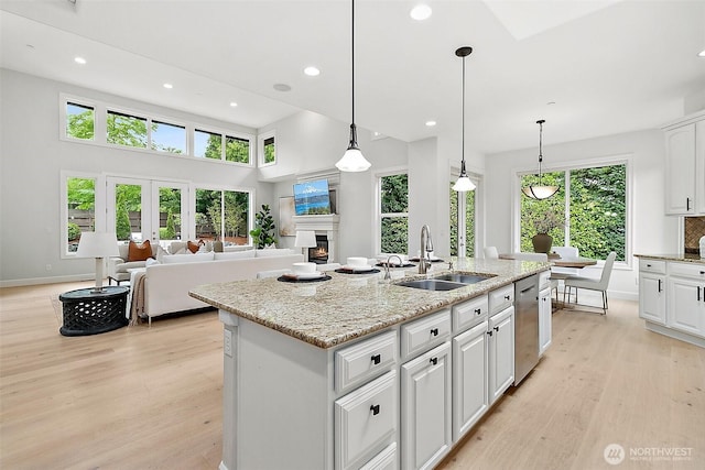 1038 Belfair Rd, Bellevue, WA 98004 - kitchen featuring a sink, stainless steel dishwasher, light wood finished floors, white cabinets, and recessed lighting