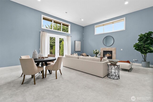 1038 Belfair Rd, Bellevue, WA 98004 - carpeted living area with plenty of natural light, a high ceiling, a fireplace, french doors, and recessed lighting