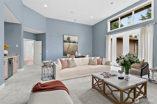 1038 Belfair Rd, Bellevue, WA 98004 - living area featuring a towering ceiling, wine cooler, light colored carpet, and recessed lighting