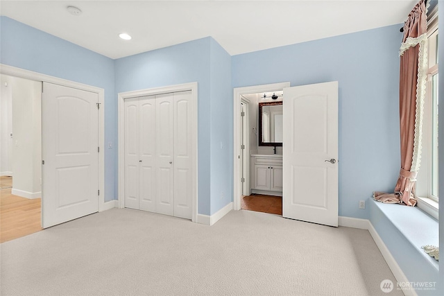 1038 Belfair Rd, Bellevue, WA 98004 - unfurnished bedroom featuring light colored carpet, baseboards, and a closet
