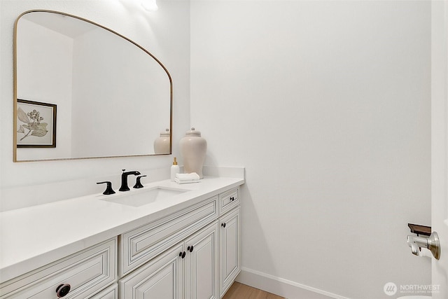 1038 Belfair Rd, Bellevue, WA 98004 - bathroom featuring vanity, baseboards, and wood finished floors