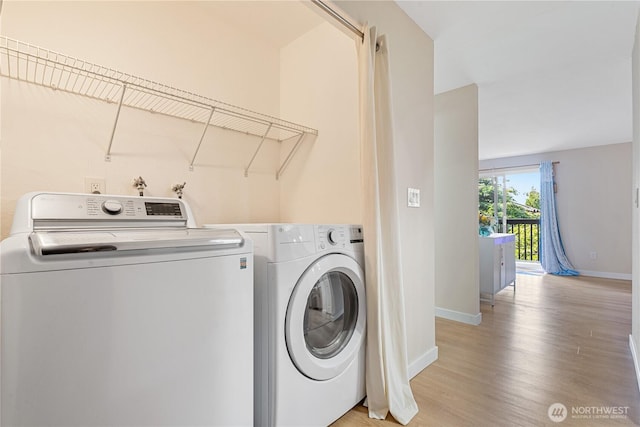 15623 NE 18th St Unit D201, Bellevue, WA 98008 - laundry area with washing machine and dryer, baseboards, and light wood-style flooring