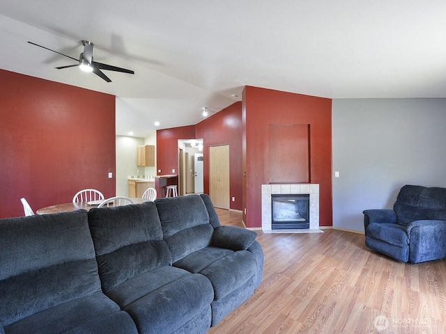 16312 72nd Ave E, Puyallup, WA 98375 - living room with light wood finished floors, vaulted ceiling, ceiling fan, and a tiled fireplace