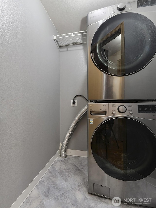 16312 72nd Ave E, Puyallup, WA 98375 - clothes washing area featuring estacked washer and dryer and baseboards