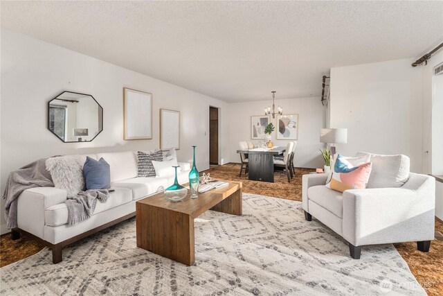 living area with a chandelier and a textured ceiling