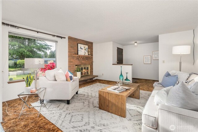 living room with a fireplace, a textured ceiling, and light carpet