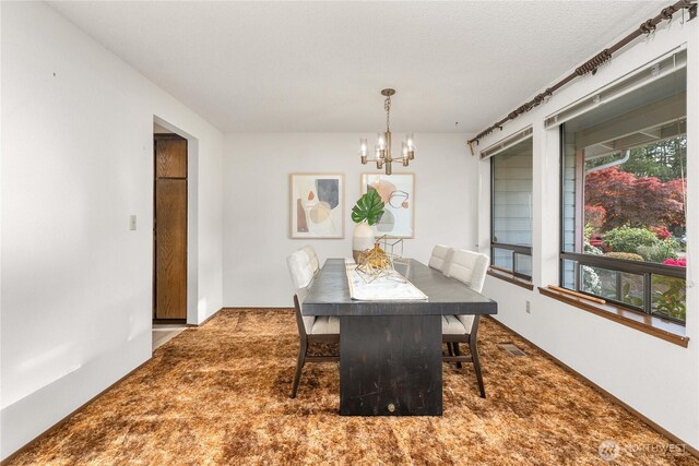 carpeted dining area featuring a chandelier