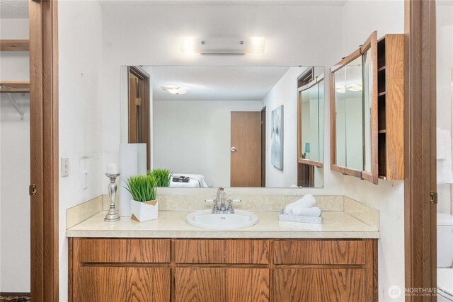 bathroom featuring vanity and toilet