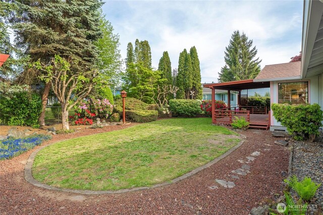view of grassy yard featuring a deck
