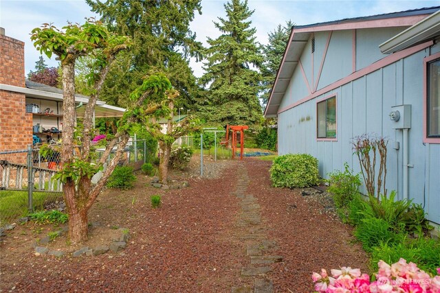 view of yard with a playground and fence