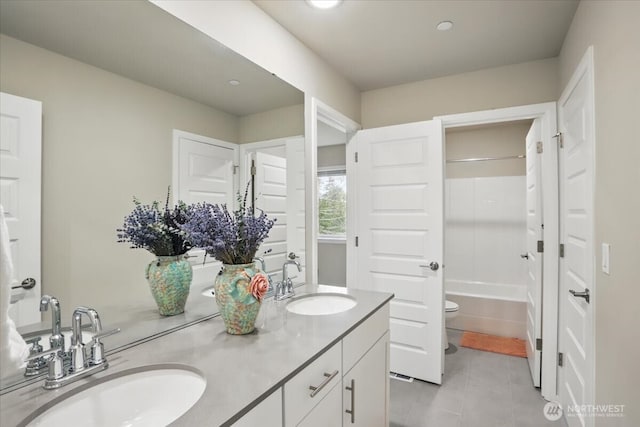 bathroom with double vanity, tile patterned flooring, toilet, shower / washtub combination, and recessed lighting