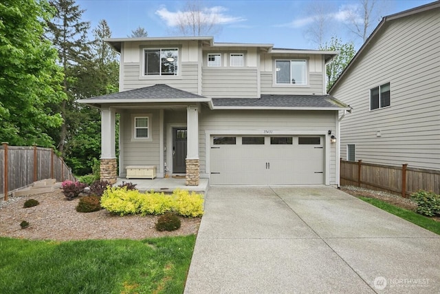 prairie-style home featuring fence, a garage, driveway, roof with shingles, and stone siding