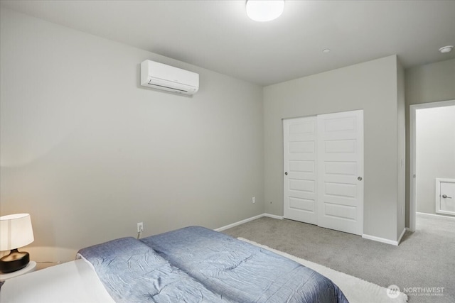 bedroom featuring an AC wall unit, carpet, baseboards, and a closet