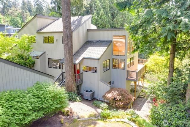 11819 73rd Pl NE, Kirkland, WA 98034 - back of property featuring roof with shingles, stairs, and central AC
