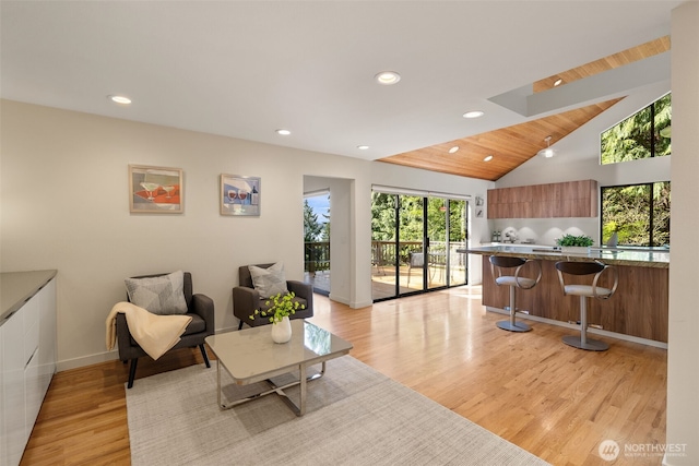 11819 73rd Pl NE, Kirkland, WA 98034 - living area featuring recessed lighting, light wood-style floors, a skylight, lofted ceiling, and baseboards