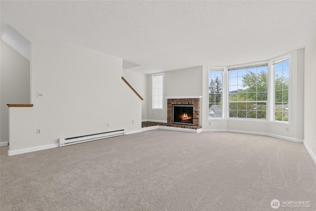 unfurnished living room with a baseboard radiator, a textured ceiling, carpet, baseboards, and a fireplace