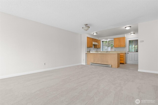 unfurnished living room featuring a baseboard radiator, light carpet, baseboards, a sink, and a textured ceiling