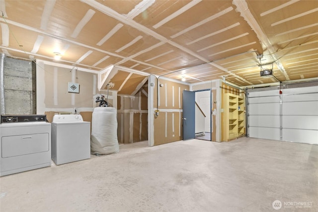 garage with separate washer and dryer and a garage door opener