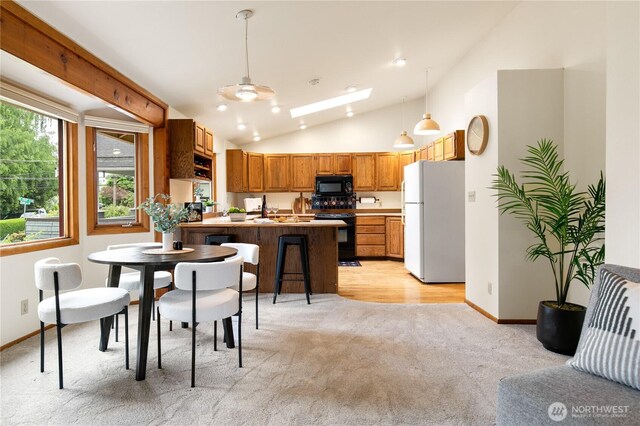12013 Exeter Ave NE, Seattle, WA 98125 - dining space with vaulted ceiling, light carpet, baseboards, and recessed lighting