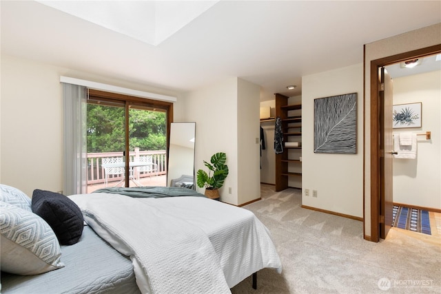 12013 Exeter Ave NE, Seattle, WA 98125 - bedroom with light colored carpet, baseboards, access to exterior, and a walk in closet