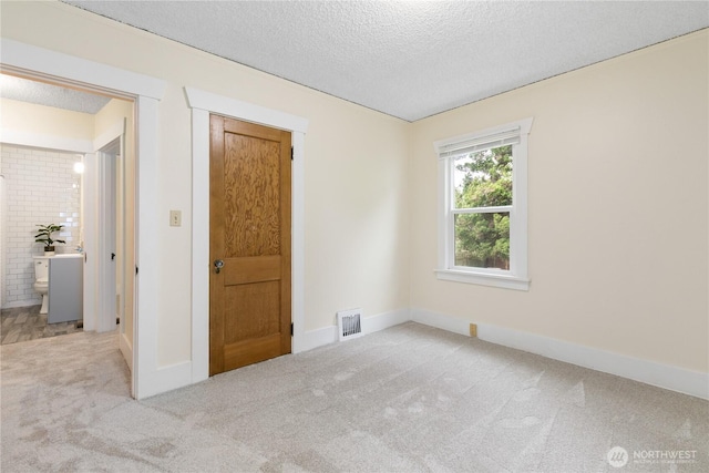 12013 Exeter Ave NE, Seattle, WA 98125 - unfurnished room featuring carpet floors, a textured ceiling, and baseboards