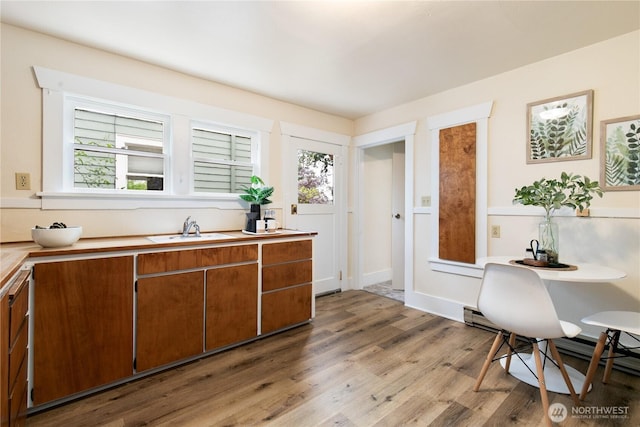 12013 Exeter Ave NE, Seattle, WA 98125 - kitchen featuring a sink, brown cabinets, light wood-type flooring, light countertops, and a baseboard radiator
