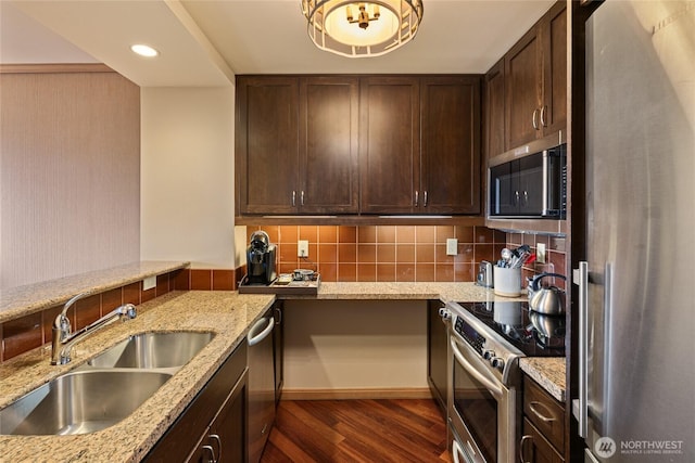 3600 Suncadia Trl Unit 2059, Cle Elum, WA 98922 - kitchen with appliances with stainless steel finishes, a sink, dark wood-style floors, decorative backsplash, and dark brown cabinetry