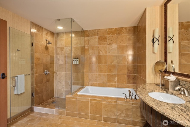 3600 Suncadia Trl Unit 2059, Cle Elum, WA 98922 - bathroom with tiled shower, a garden tub, tile walls, tile patterned floors, and vanity