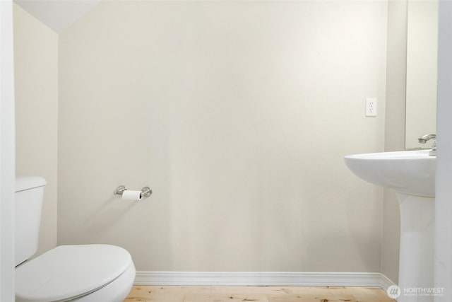 24045 40th Ln SE, Bothell, WA 98021 - bathroom featuring toilet, baseboards, and a sink