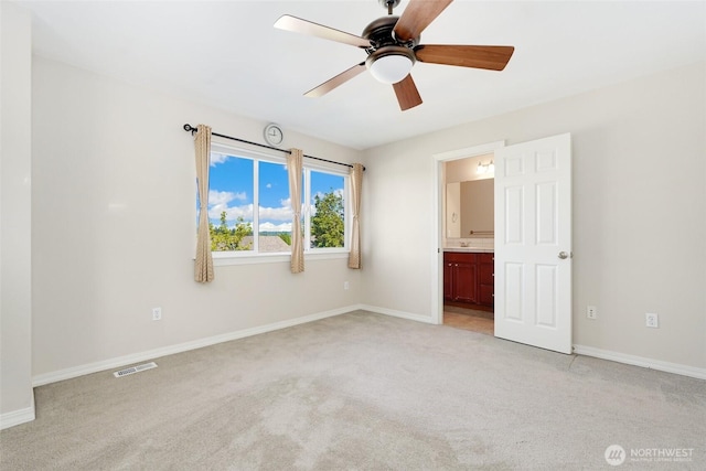 unfurnished bedroom with light colored carpet and baseboards
