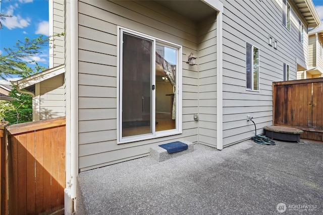 view of side of home featuring a patio and fence
