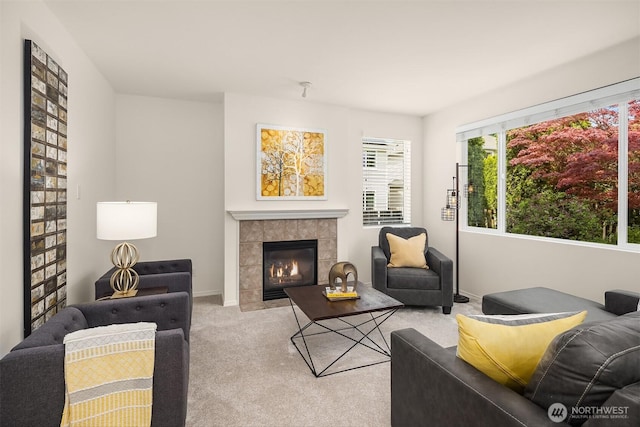 24521 SE 275th St, Maple Valley, WA 98038 - living room featuring a tiled fireplace, light carpet, and baseboards