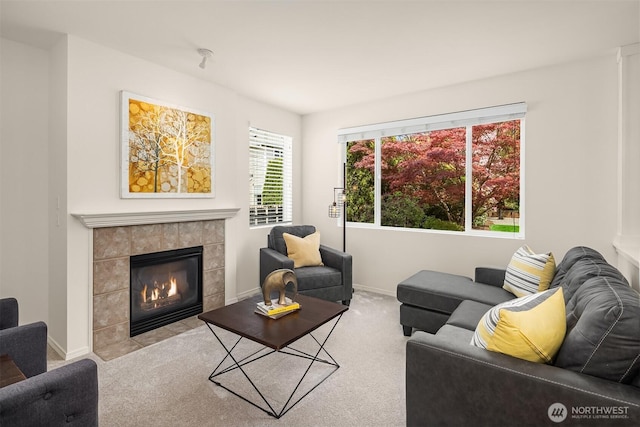 24521 SE 275th St, Maple Valley, WA 98038 - carpeted living area with a tile fireplace, baseboards, and healthy amount of natural light