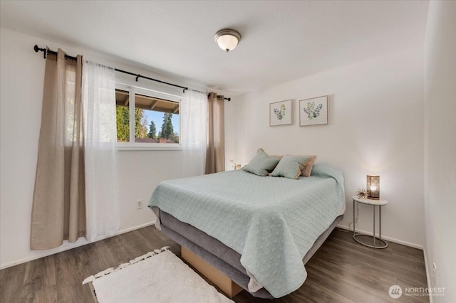 bedroom featuring wood finished floors and baseboards