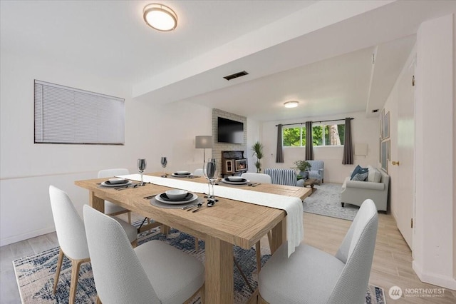 dining area featuring light wood-type flooring and baseboards