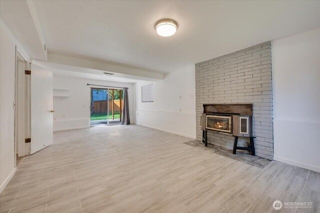 unfurnished living room featuring light wood-style floors and baseboards