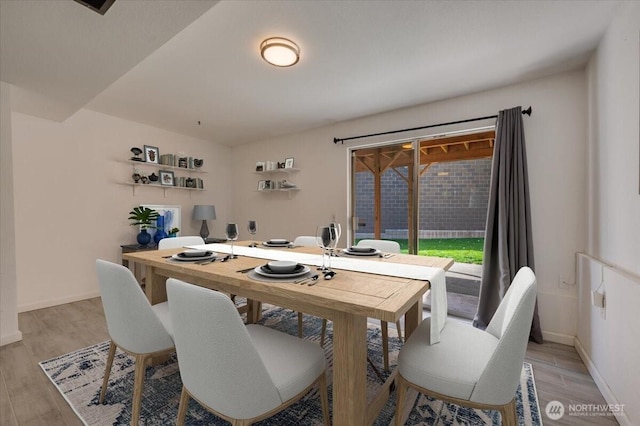 dining room with light wood-type flooring, baseboards, and an office area